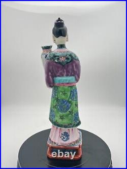 A Chinese famille rose court lady vase holder, Qianlong period, 18th century